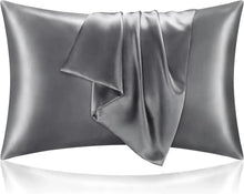 A pair of satin pillowcases on a made bed, showing the sheen of the fabric